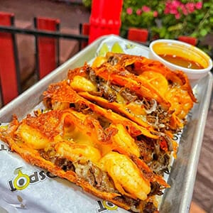 A tray of tacos on a table.